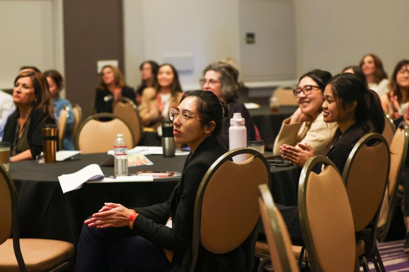 Long Beach, CA - November 15: People in the audience clap during the "The Joy and Agony of Creating Cambodia Town," forum during the Cambodia American Studies Conference at Hilton Long Beach on Friday, Nov. 15, 2024 in Long Beach, CA. (Michael Blackshire / Los Angeles Times)