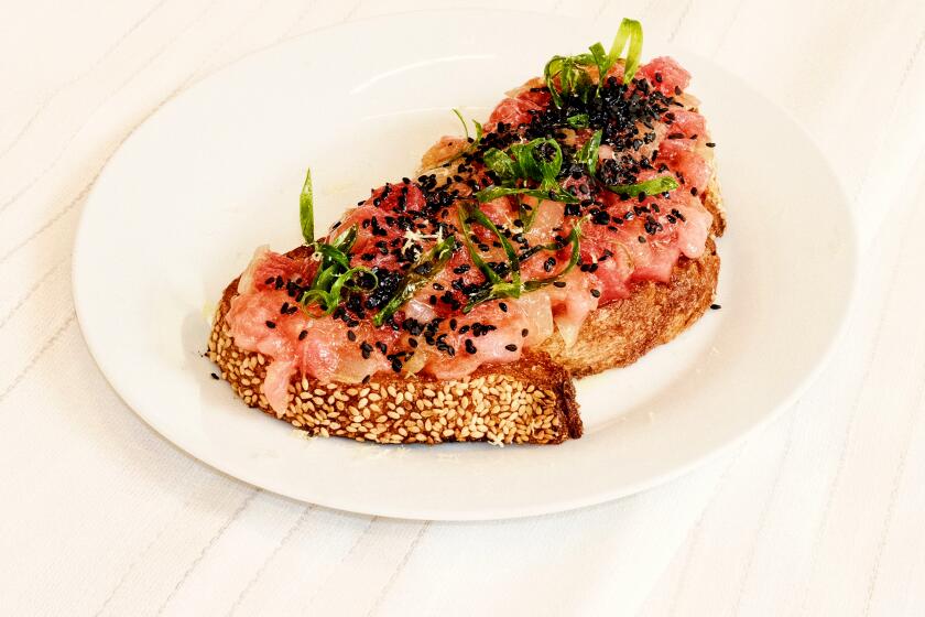 Crudo e Nudo chef Brian Bornemann prepares tuna toast with shrimp stock in the L.A. Times Test Kitchen.