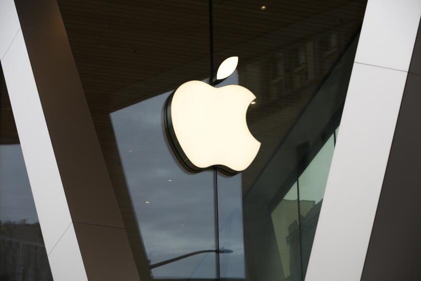 FILE - In this Saturday, March 14, 2020, file photo, an Apple logo adorns the facade of the downtown Brooklyn Apple store in New York. Apple's shareholders have approved a proposal Friday, March 4, 2022, urging the iPhone maker to undergo an independent audit assessing its treatment of female and minority employees, delivering a rare rebuke to a management team that runs the world's most valuable company. (AP Photo/Kathy Willens, File)