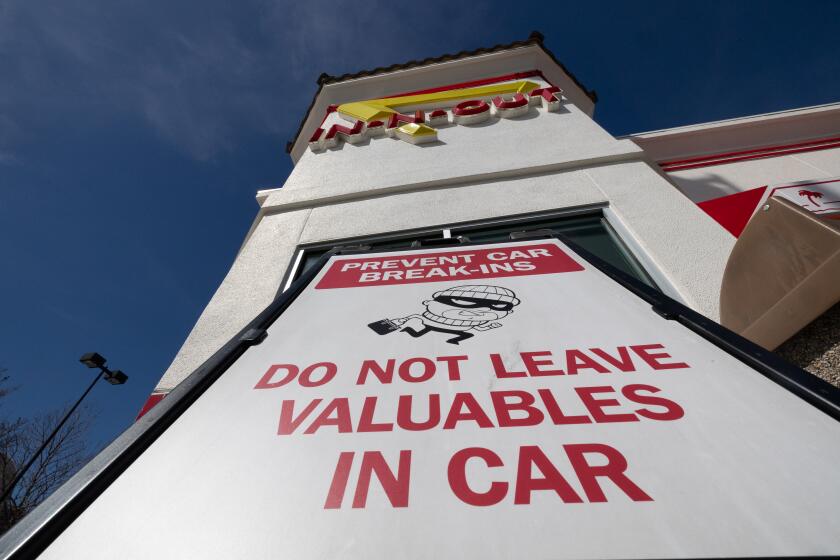 OAKLAND CA FEBRUARY 27, 2024 - A large warning sign in front of the In-N-Out restaurant on Tuesday, Feb. 27, 2024 in Oakland, Calif. The fast-food chain on Sunday said it would close its only Oakland location over safety concerns for its customers and employees. (Paul Kuroda / Fro The Times)