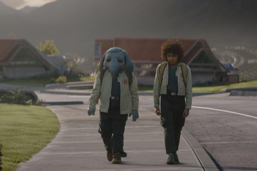 two boys walking on a sidewalk