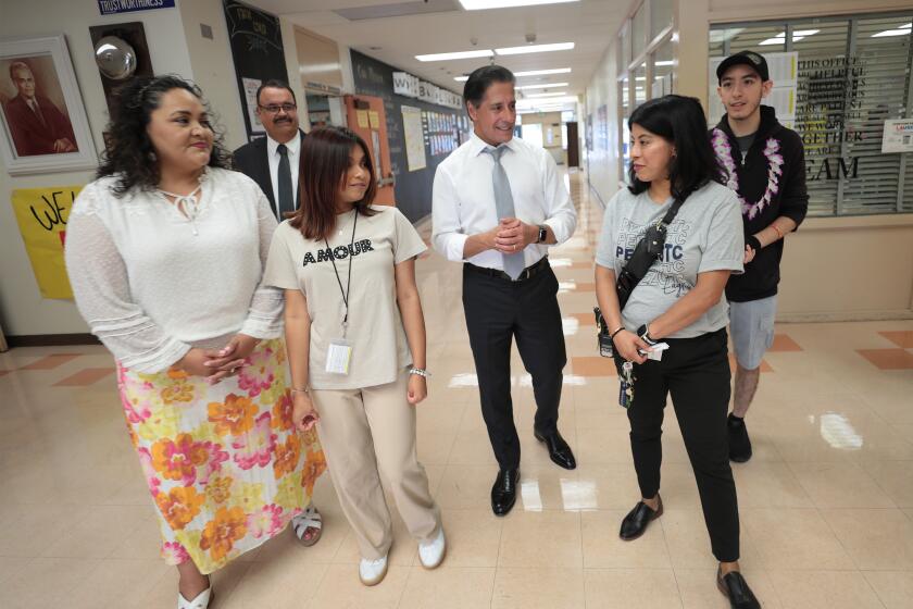 Los Angeles, CA - August 12, 2024: Los Angeles Unified Superintendent Alberto M. Carvalho and LAUSD District 2 Board Member Dr Rocio Rivas, left, talk with student ambassador Edith Duran, and Principal Manuela Hernandez, right, as the Superintendent tours Alfonso B. Perez Career Transition Center on the first day of the 2024-25 school year. (Al Seib / For The Times)