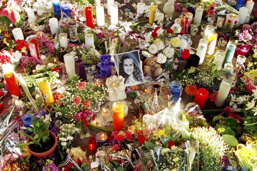 Flowers and candles surround a photo of 12-year-old Polly Klass in Petaluma, California, December 5, 1993 the day her body was found. On October 1, 1993, she was kidnapped at knife point during a slumber party at her mother's home and was later strangled. (NewsBase / AP)