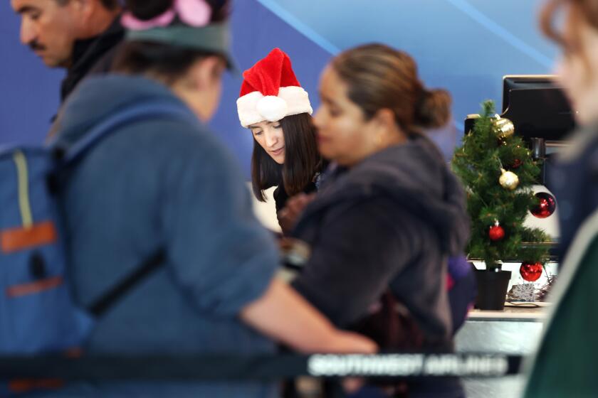 LOS ANGELES, CA, DECEMBER 20, 2024: Travelers check-in at Southwest at LAX on Friday, December 20, 2024. (Christina House / Los Angeles Times)