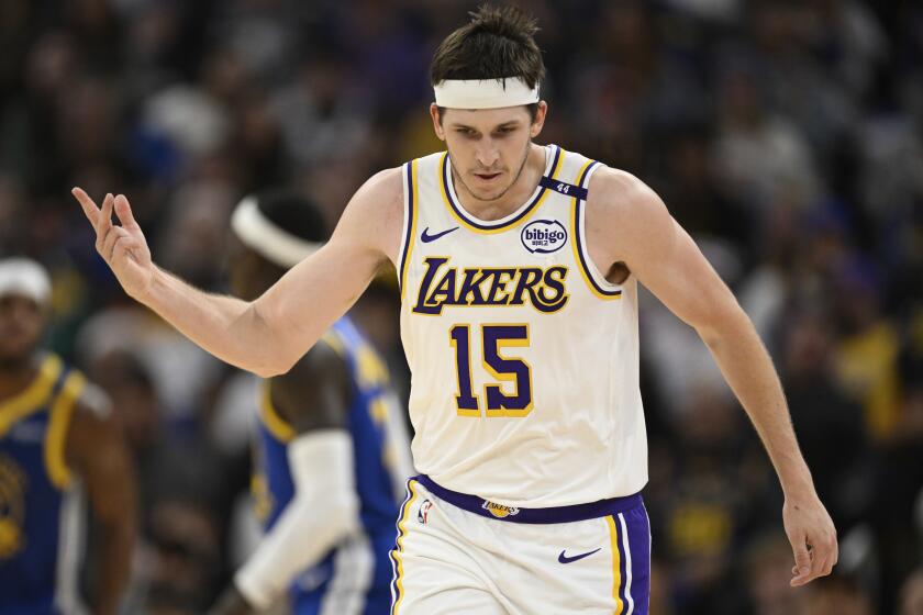 Los Angeles Lakers guard Austin Reaves (15) celebrates his three-point basket.