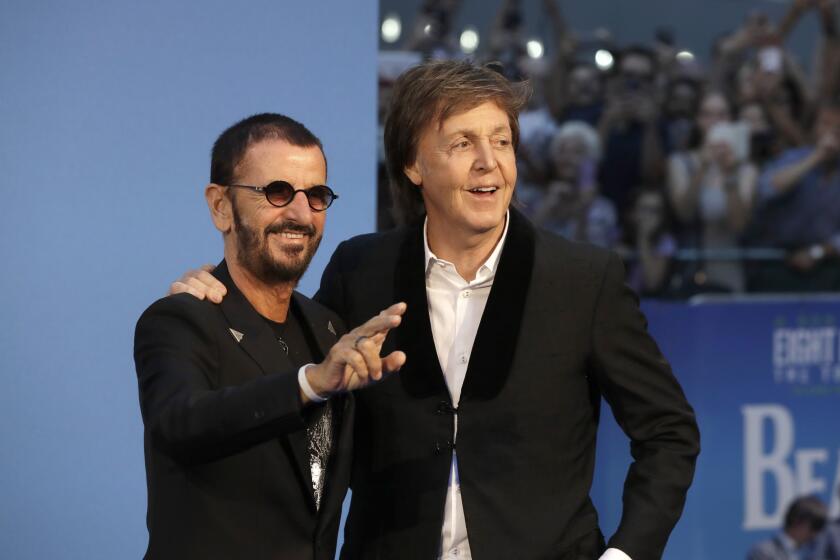 Former Beatles Paul McCartney, right, and Ringo Starr pose in suits at the 2016 premiere of "The Beatles, Eight Days a Week"