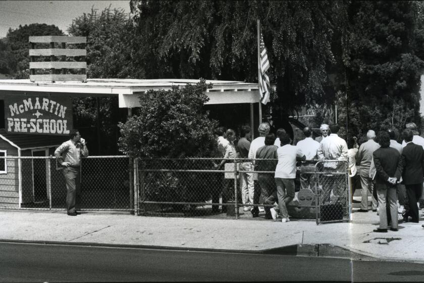 Jurors of the McMartin case visit the McMartin Preschool in Manhattan Beach, California, April 19, 1989, that had been restored to the way it looked at the time of alleged molestations that caused the school closure. Judge William Pounders talks to the jurors answering questions through the walkthrough. Photo Credit: Lacy Atkins / Los Angeles Times