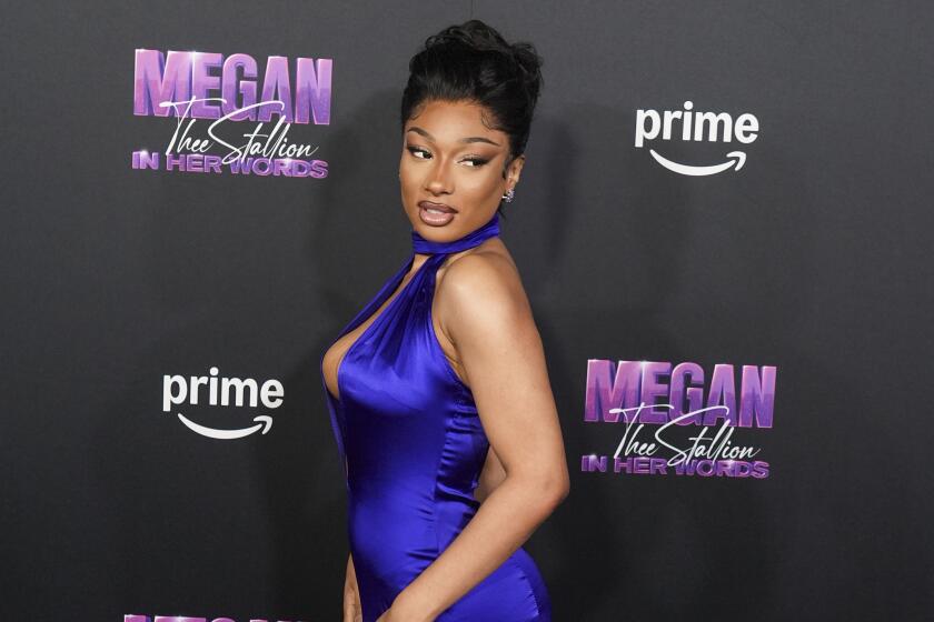 Megan Thee Stallion poses in blue gown at the Oct. 2024 premiere of "Megan Thee Stallion: In Her Words" in L.A.