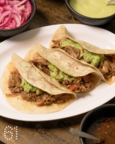 INGLEWOOD, CA - OCTOBER 22, 2024: A trio of the tacos de desebrada "Chikali Style" (with beans and guacamole) on house made flour tortillas at Asadero Chikali in Inglewood. (Ron De Angelis / For The Times)