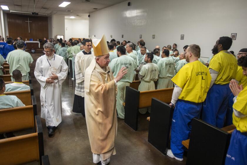 Los Angeles, CA - December 25: Archbishop Jose Gomez, greets with inmates after a Christmas Day mass at Men's Central Jail Wednesday, Dec. 25, 2024 in Los Angeles, CA. (Ringo Chiu / For The Los Angeles Times)