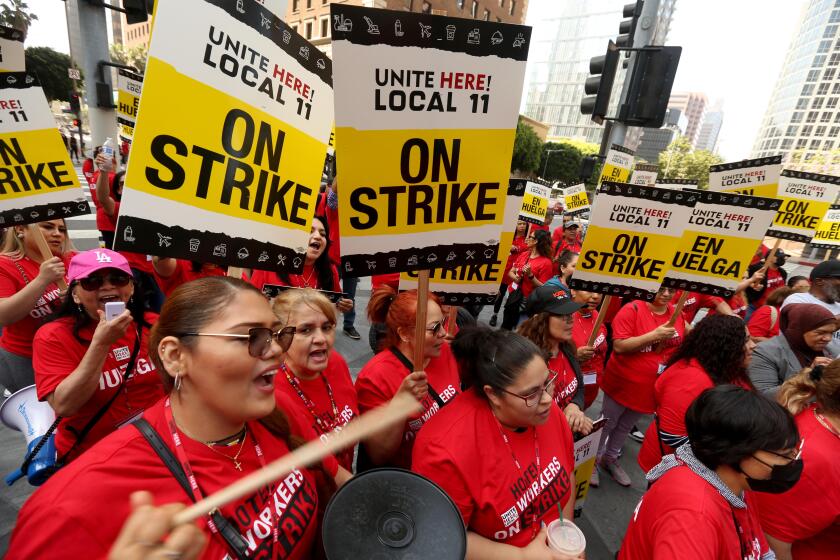 LOS ANGELES, CA - JULY 2, 2023 - Hotel workers picket in front of the Intercontinental Hotel as members of Unite Here Local 11 joined dozens of other southland hotels who went on strike today in downtown Los Angeles on July 2, 2023. Hotel workers formed picket lines at many of the businesses in an effort to secure higher pay and improvements in health care and retirement benefits. The contract between the hotels and Unite Here Local 11 expired at 12:01 a.m. on Saturday (Genaro Molina / Los Angeles Times)