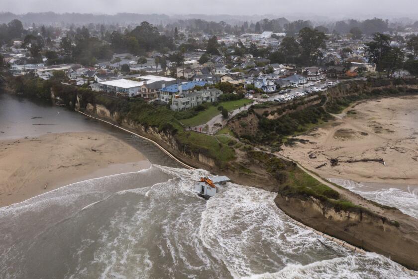 Remnants of a bathroom that fell off the wharf are seen at the mouth of the San Lorenzo River in Santa Cruz, Calif., Tuesday, Dec. 24, 2024. (AP Photo/Nic Coury)