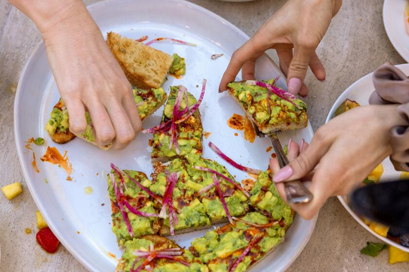 Soho House Run Club participants dig into avocado toast at the Soho House Holloway rooftop deck.