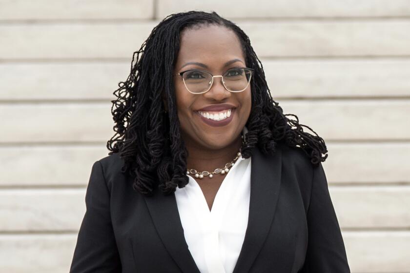 Justice Ketanji Brown Jackson smiles in a suit after her 2022 investiture ceremony at the Supreme Court, in Washington, D.C.