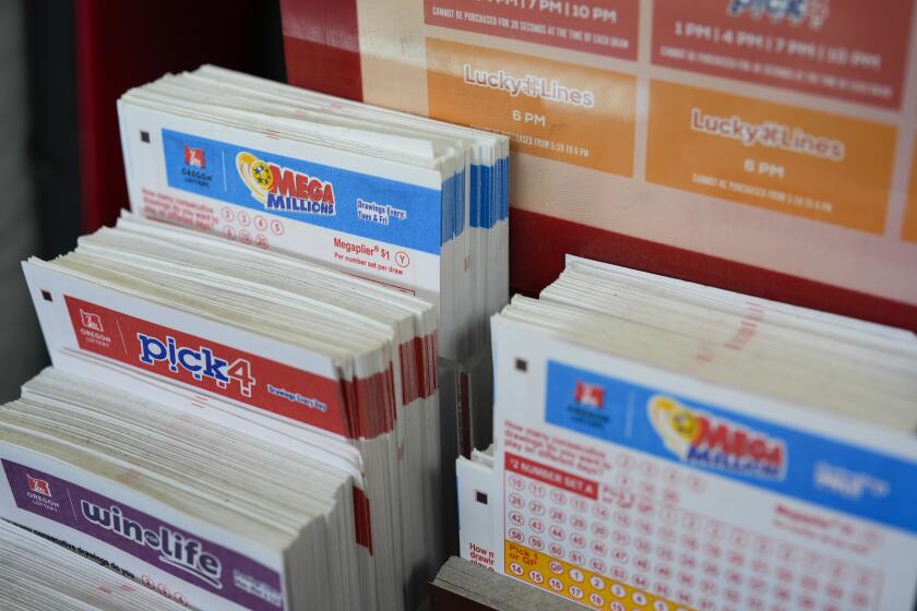 A stand with Oregon Lottery pick your own number tickets are displayed at a 7-Eleven on Friday, April 5, 2024, in Portland, Ore. (AP Photo/Jenny Kane)