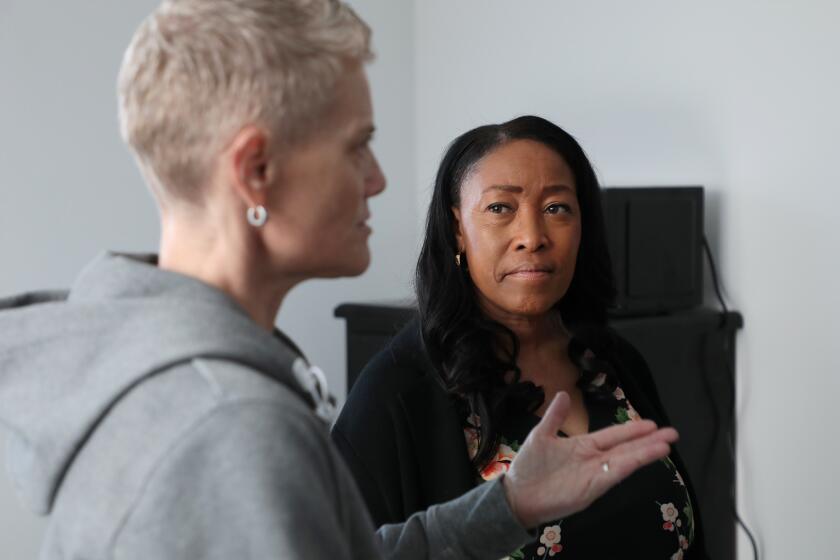 Los Angeles, CA - December 11: University Park on Monday, Dec. 11, 2023 in Los Angeles, CA. Kris Freed, left, a consultant with LAHSA and Va Lecia Adams Kellum, right, CEO of LAHSA tour a new building at 1200 Leighton Ave that has been master-leased by LAHSA on behalf of LA City for Mayor Bass' Inside Safe program. Rapid multi-story student-oriented development is transforming the bungalow neighborhood west of USC. There is focus on two or three blocks between Exposition and Jefferson, Vermont and Western where three-to five-story buildings are recently completed or under construction in an area with long-term residents. The tour of a new building that has been master-leased by LAHSA is part of the gentrification of the neighborhood but also reflects the city's response to the shortage of affordable housing and the value-clash that is the underlying theme of the story. (Al Seib / For the Los Angeles Times)