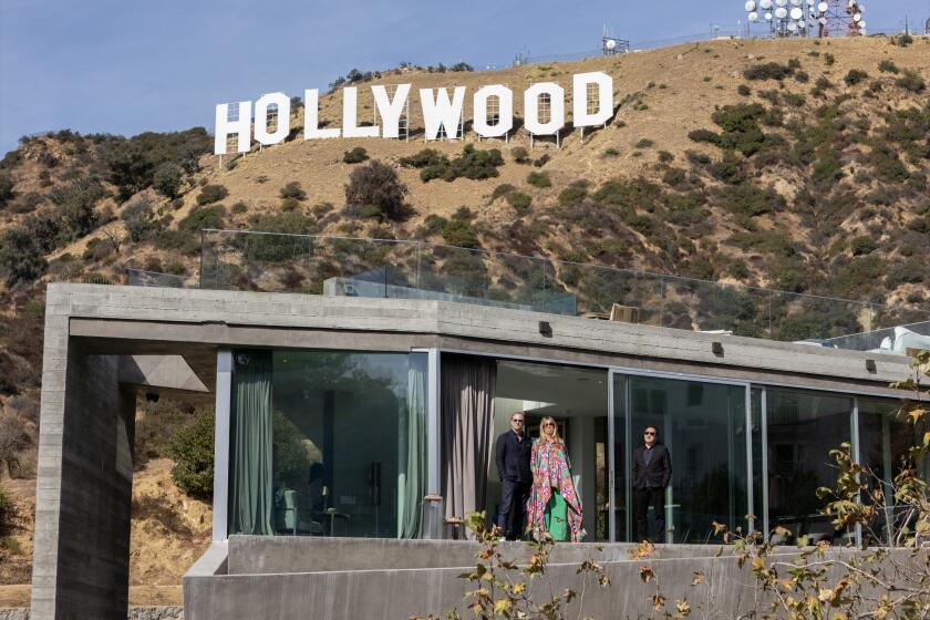 LOS ANGELES, CA - NOVEMBER 06: The Grueter Residence is built directly on a hillside at the base of the Hollywood sign. The home was designed by architect Yo Hakomori, right, of StudioHAU for the European couple Andreas and Nina Grueter who are engaged in visionary real estate projects, ventures and art. Photographed at Grueter Residence in Los Angeles, CA on Wednesday, Nov. 6, 2024. (Myung J. Chun / Los Angeles Times)